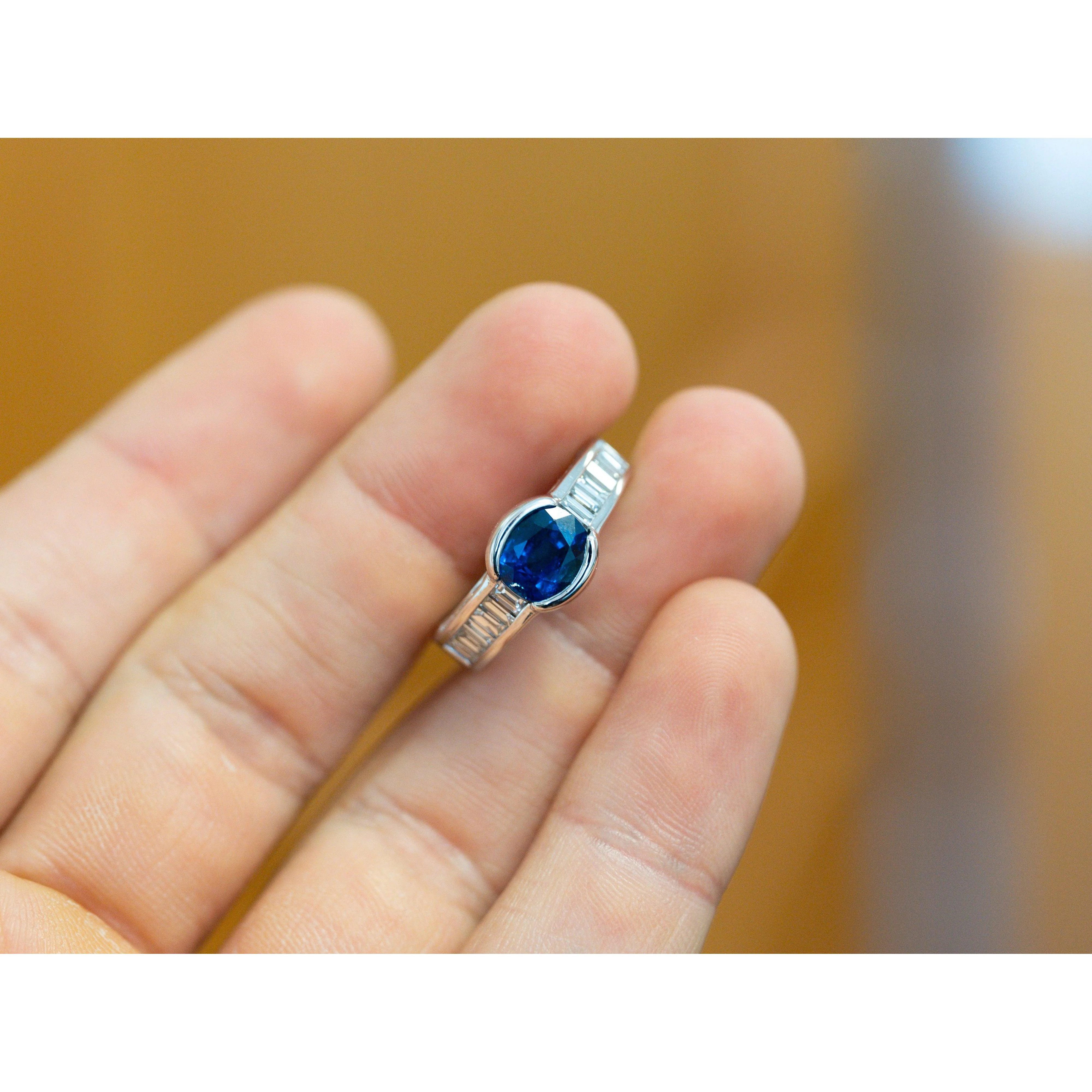 18K White Gold Bezel and Channel Set Oval Cut Blue Sapphire & Baguette Diamond Ring - Image 3